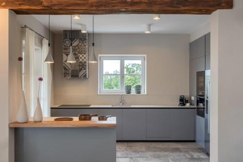 a kitchen with a sink and a window at Villa Julia - Luxury villa with sea view in Razvala