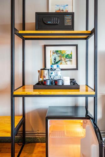 a shelf with a microwave on top of it at W22 by Burasari in Bangkok