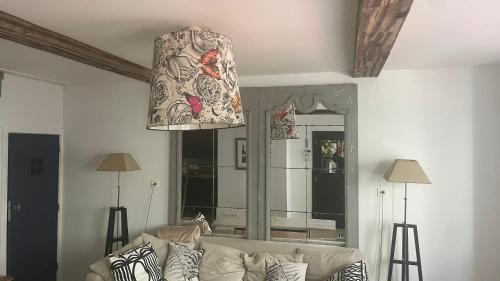 a living room with a couch and a large mirror at The Refuge of Happiness in Bouillon