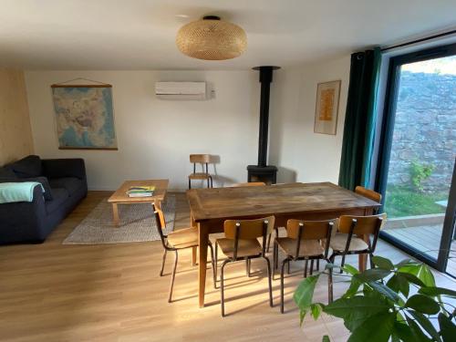 a living room with a wooden table and chairs at Clos Sauvage in Leynes