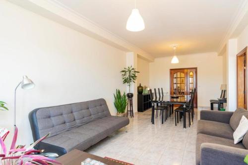 a living room with a couch and a table at Olival Comfortable Room I in Vila Flor