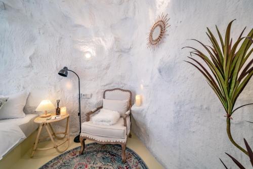 a room with a chair and a table with a plant at Xiaolu Chain Luxury Designer Homestay in Guiyang