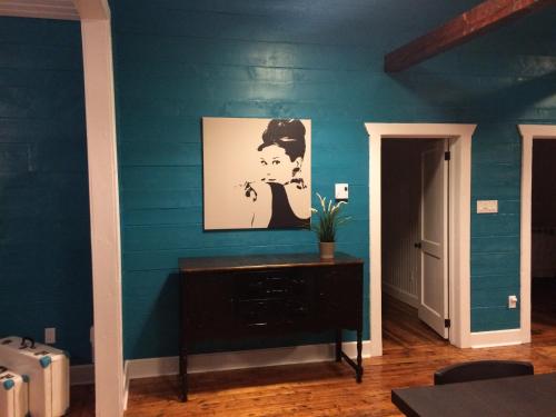 ein Zimmer mit einer blauen Wand mit einem Gemälde darauf in der Unterkunft The Old Salt Box Co. - Aunt Donna's in Musgrave Harbour