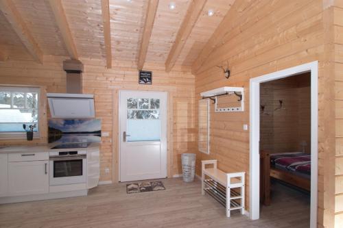 a room with a door leading to a kitchen and a bedroom at Haus beim See in Clausthal-Zellerfeld