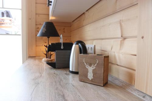 a room with wooden walls and a table with a lamp at Haus beim See in Clausthal-Zellerfeld