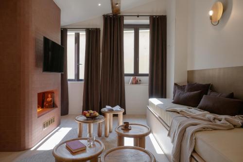 a living room with a couch and a fireplace at MiHotel Le Gourguillon in Lyon