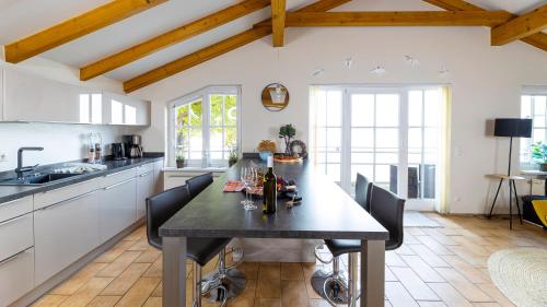 a kitchen and dining room with a table and chairs at Haus Seeblick mit 9 Wohnungen in Alt Reddevitz