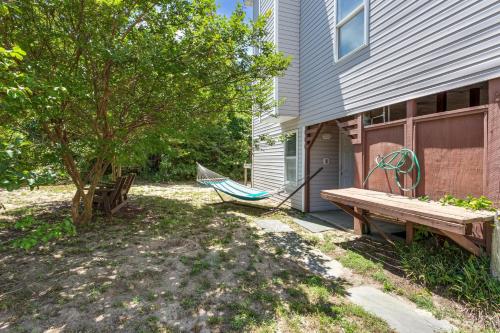 a hammock sitting outside of a house next to a tree at 2027 - Sunny Lagoon in Sanderling