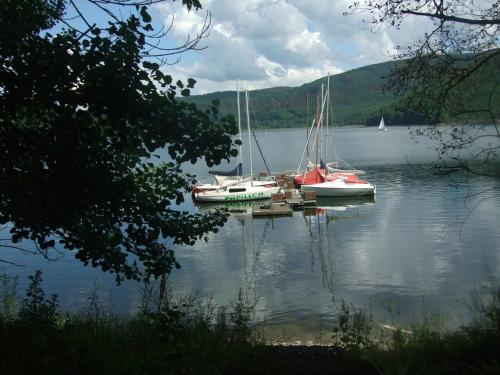 three sailboats are docked on a large lake at Bienenhaus 1 in Monschau