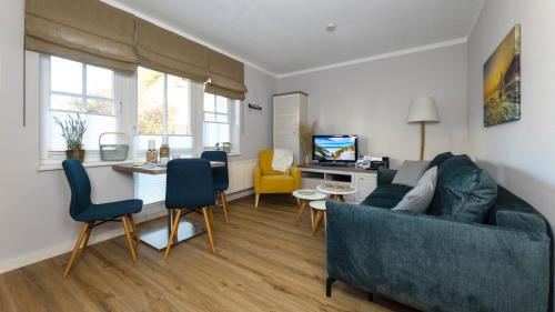 a living room with a couch and a table at Haus Seeblick mit 9 Wohnungen in Alt Reddevitz