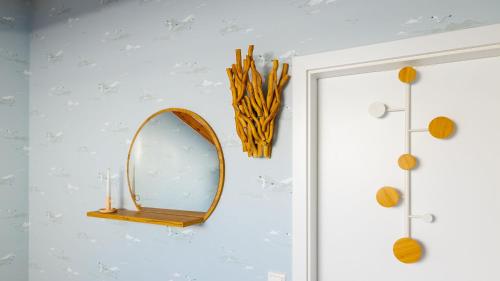a mirror hanging on a wall next to a door at Haus Seeblick mit 9 Wohnungen in Alt Reddevitz