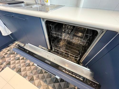 an oven with its door open in a kitchen at Sea View Appartment Seeb in Ḩayl Āl ‘Umayr