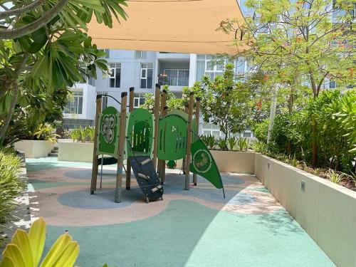 a playground in front of a building at Sea View Appartment Seeb in Ḩayl Āl ‘Umayr