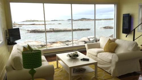 a living room with a view of the ocean at The Old Salt Box Co. - Aunt Christi's in Greenspond