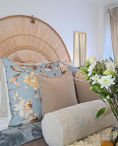 a bed with a bunch of pillows on it at Boutique Apartment Bloubergstrand Beachfront The Bay in Bloubergstrand