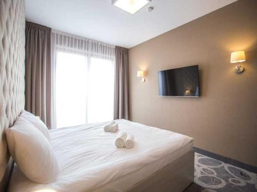 a hotel room with a bed with towels on it at Hotel Rondo in Wąbrzeźno