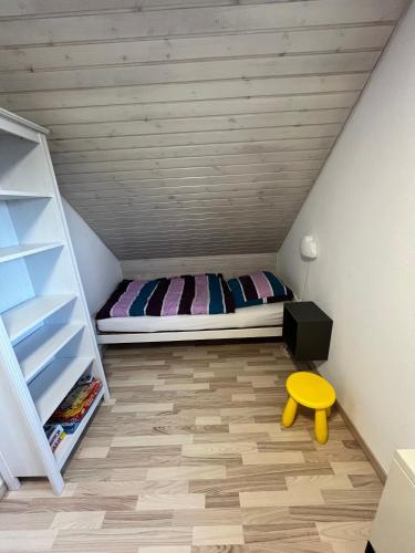 a bedroom with a bed in a attic at Ferienhaus 'Welle und Watt' - 2024 neu renoviert in Friedrichskoog-Spitz