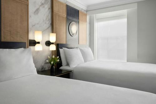 two beds in a hotel room with white sheets at Marriott Vacation Club® at the Mayflower, Washington, D.C.  in Washington