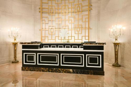 a lobby with a desk with two candles and a wall at Marriott Vacation Club® at the Mayflower, Washington, D.C.  in Washington