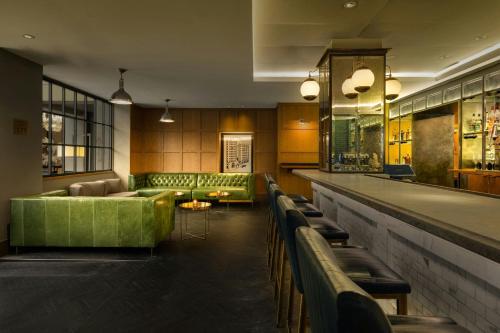 a lobby with a green couch and a bar at Marriott Vacation Club® at the Mayflower, Washington, D.C.  in Washington