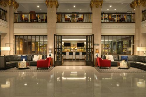a lobby with couches and red chairs in a building at Marriott Vacation Club® at the Mayflower, Washington, D.C.  in Washington