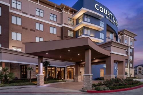 a rendering of the front of a hotel at Courtyard By Marriott Houston Kingwood in Kingwood