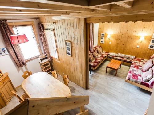 un salon avec une table et un canapé dans l'établissement Duplex cosy 6 pers à 150m des pistes avec parking gratuit, balcon, appareils à raclette et fondue - FR-1-329-86, à La Plagne Tarentaise