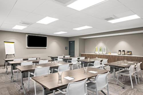 a classroom with tables and chairs and a flat screen tv at EVEN Hotel Portland - Beaverton by IHG in Portland