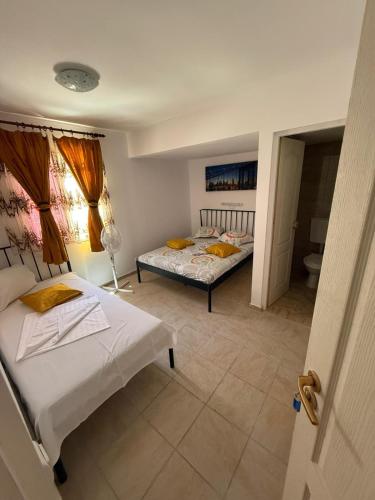a bedroom with two beds and a bathroom at Obelisc Costinesti in Costinesti