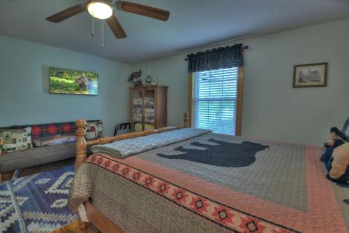 a bedroom with a large bed in a room at Bear Naked Hideaway - Relax in the hot tub with sounds from the nearby creek in Epworth