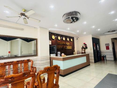 a restaurant with a bar with a ceiling fan at Ngọc Châu Hotel Hồ Chí Minh in Ho Chi Minh City