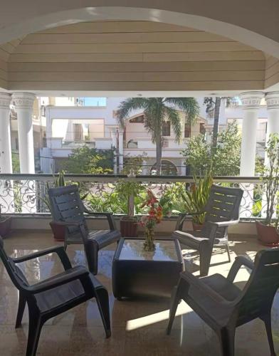 a group of chairs and a table on a balcony at Ojas Luxury and Peaceful Hotel in Manāli