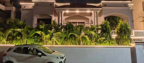 a white car parked in front of a house at Ojas Luxury and Peaceful Hotel in Manāli