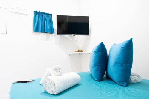 a room with blue pillows and towels on a bed at Da Giuseppina in Ercolano