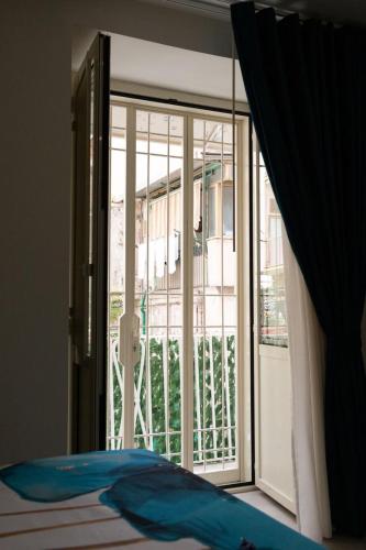 a bedroom with a bed and a sliding glass door at Da Giuseppina in Ercolano