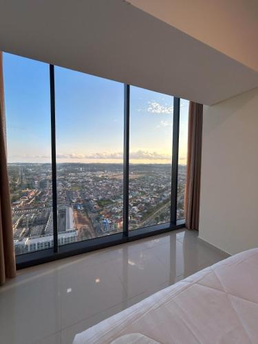 a bedroom with a view of a city at 53rd Floor, 2 BR, Netflix, Apt with view by SKY in Batam Center