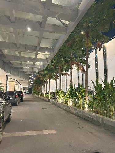 a parking lot with palm trees in a building at 53rd Floor, 2 BR, Netflix, Apt with view by SKY in Batam Center