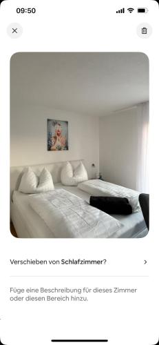 a screenshot of a bedroom with two beds in it at Appartementshaus Vlora 2 App 2 in Bad Füssing