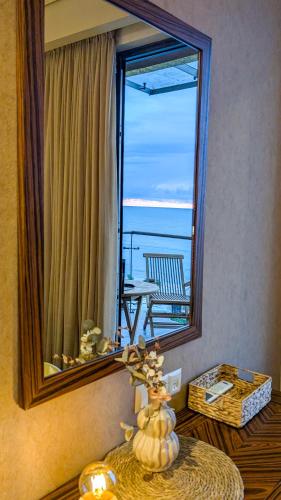 a mirror in a room with a view of the ocean at Luxury Dreamland Oasis Apartments in Chakvi