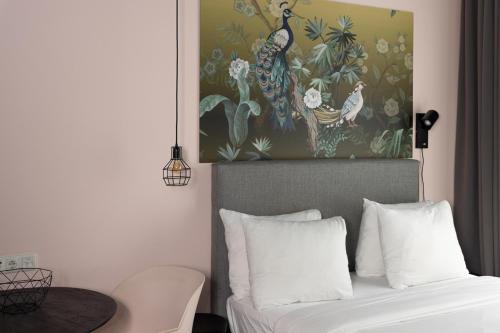 a bedroom with a bed with a painting on the wall at Hotel2Stay in Amsterdam