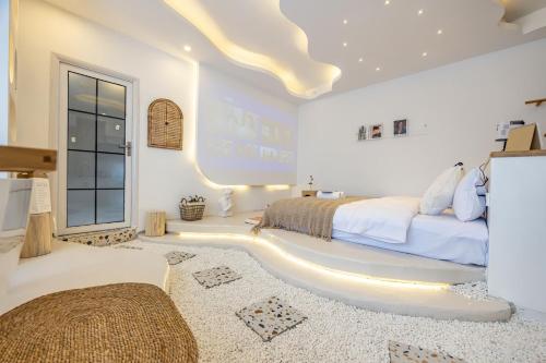 a white bedroom with a bed and a large window at Xiaolu Chain Luxury Designer Homestay in Guiyang