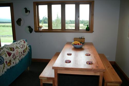 a room with a table with a bowl of fruit on it at Torokiki bach in Springfield
