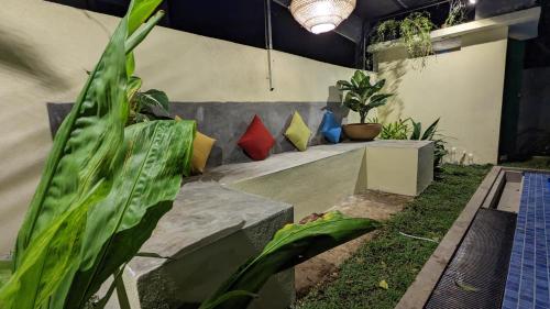 a group of pillows sitting on a bench in a garden at Soul Villas & Cabana Near Beach with Pool in Tangalle