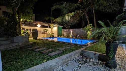 a swimming pool in a yard at night at Soul Villas & Cabana Near Beach with Pool in Tangalle
