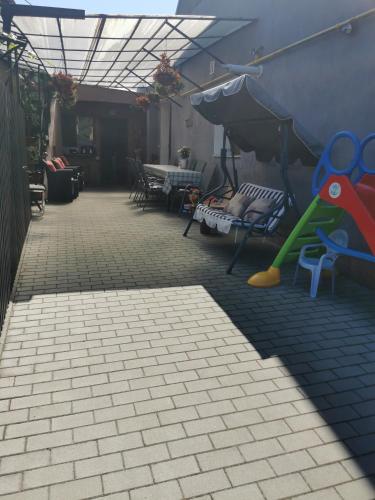 a patio with a play area with a playground at Fully Furnished Studio in Sighetu Marmaţiei