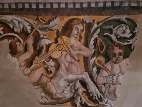 a painting of a woman holding a instrument at Palazzo Ai Capitani in Peschiera del Garda
