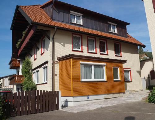 a house with a wooden fence in front of it at Ferienwohnung Schelklewiese in Baiersbronn