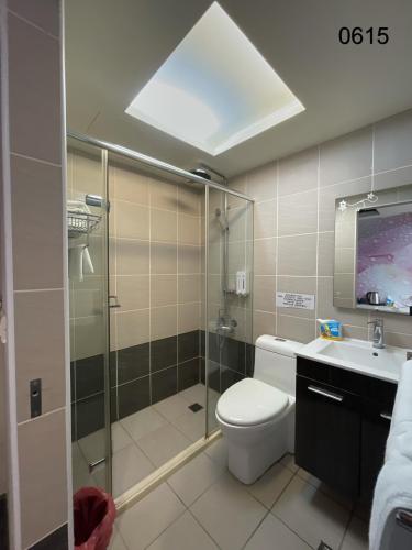 a bathroom with a shower and a toilet and a sink at 勤天行旅-嘉義站前 in Chiayi City