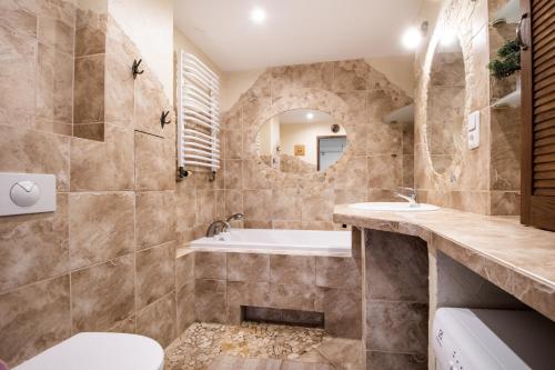 a bathroom with a tub and a sink at Apartament Centrum in Warsaw