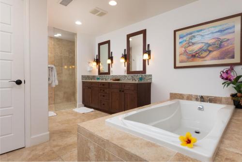 a large bathroom with a large tub and a sink at PINEAPPLE HALE Lovely 4BR KaMilo Home with Private Beach Access in Waikoloa